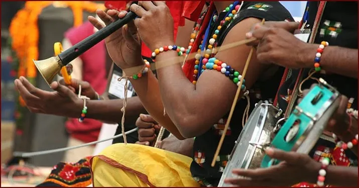Traditional Indian musicians playing classical instruments at a cultural festival, showcasing vibrant attire and rhythmic per