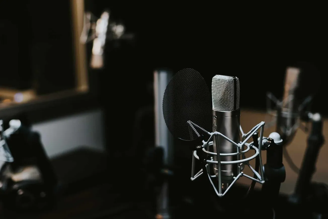 High-quality studio microphone with pop filter in a professional recording booth for music, podcasting, or voice-over product