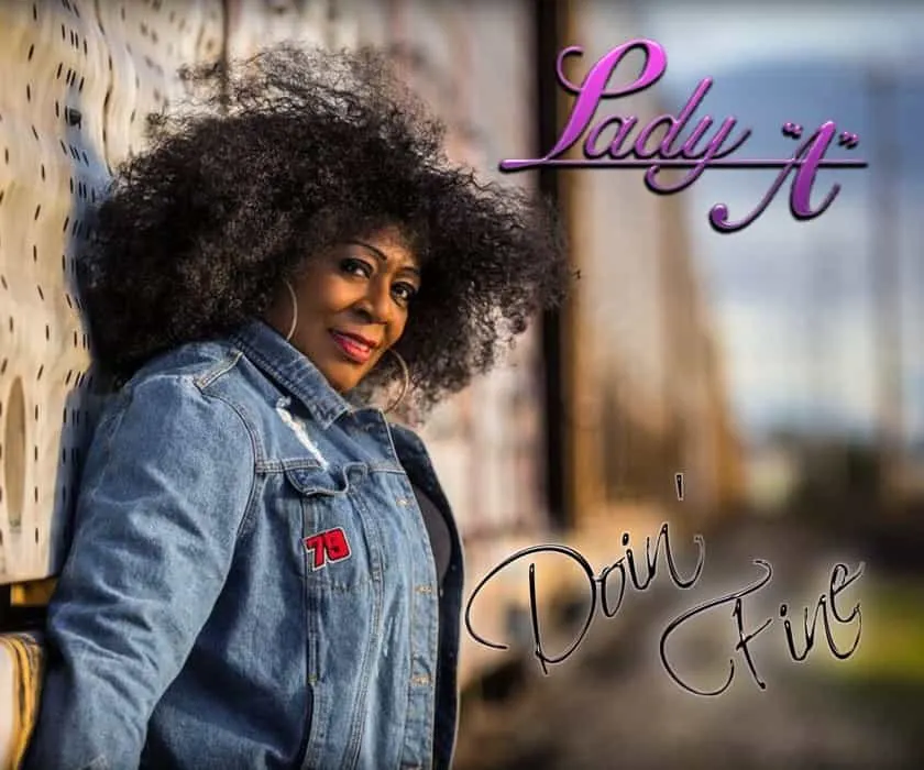 Lady 'A' posing outdoors in casual denim jacket, with a natural hairstyle, evoking confidence and individuality, promoting em