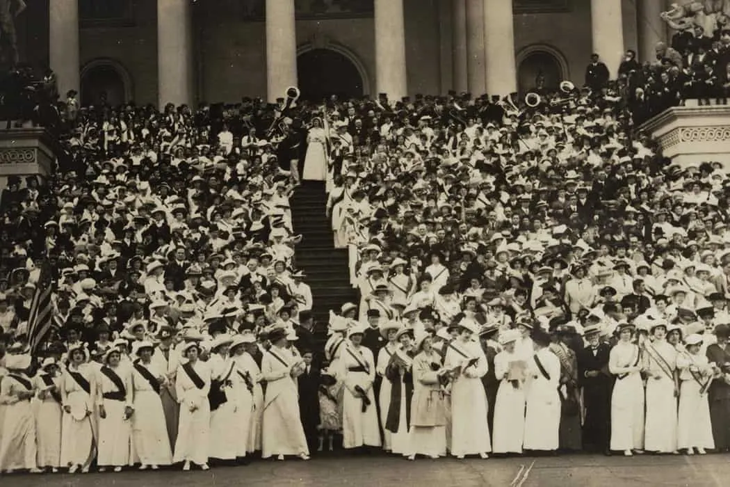 Massive crowd of people gathered on steps of government building, historic black and white photograph, early 20th-century pub