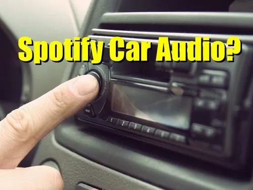 Streamlined car audio system with someone adjusting the radio in a vehicle dashboard.