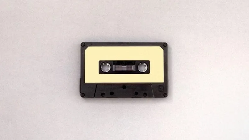 Vintage cassette tape on a plain background, representing music, audio, and media storage.