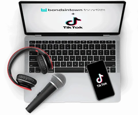 Earphone, microphone, and smartphone with TikTok logo on a laptop keyboard, representing music promotion and social media mar