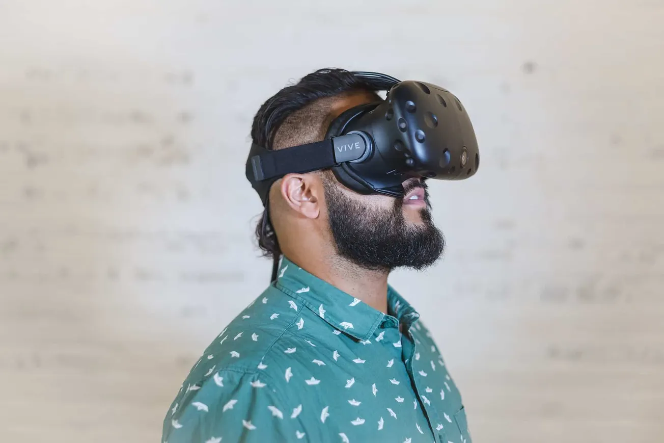 VR headset user experiencing immersive virtual reality, wearing HTC Vive virtual reality goggles for gaming or digital experi