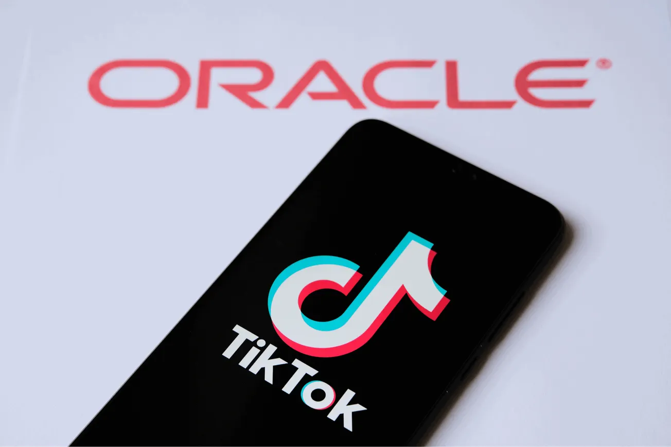 Oracle logo and TikTok app on smartphone screen with Hypebot branding, representing social media marketing, digital entertain