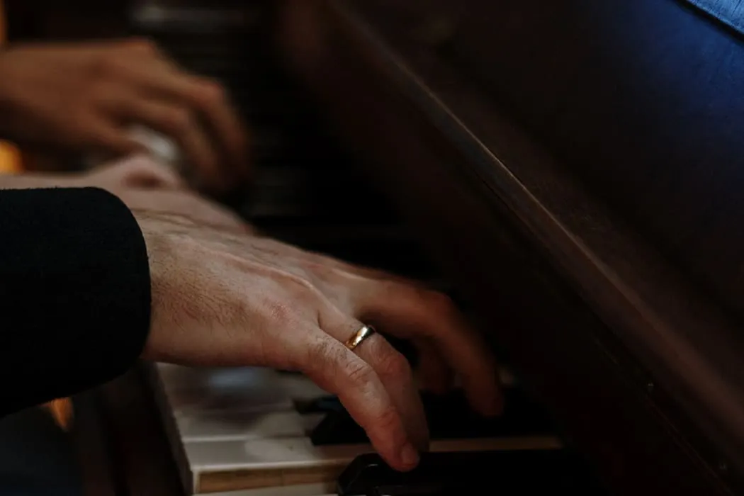 A close-up of hands playing piano, showcasing passion for music and musical talent.
