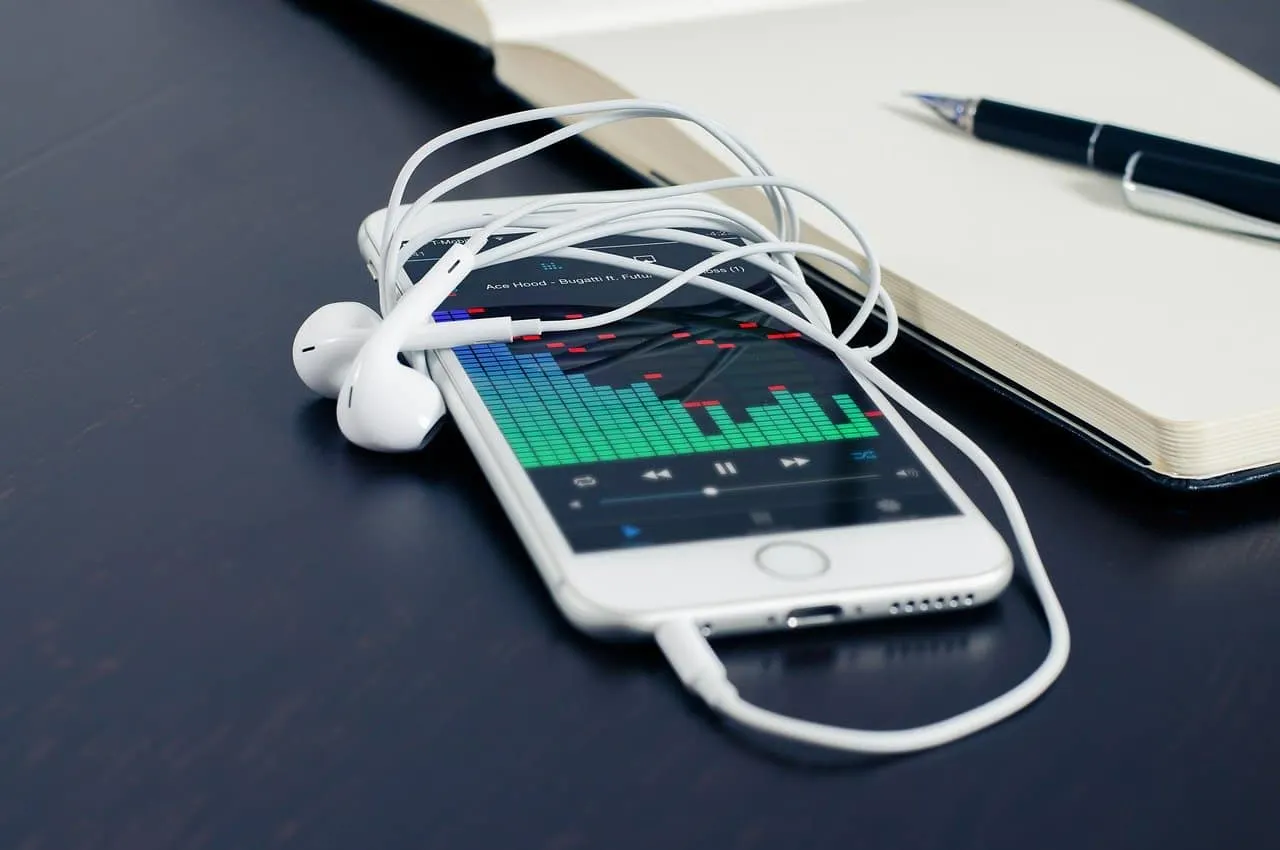 Music streaming on smartphone with earphones and digital audio visualization.