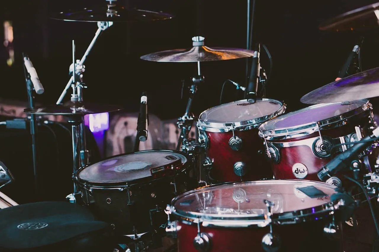 Drum set with cymbals and microphones in a music studio or stage setup.