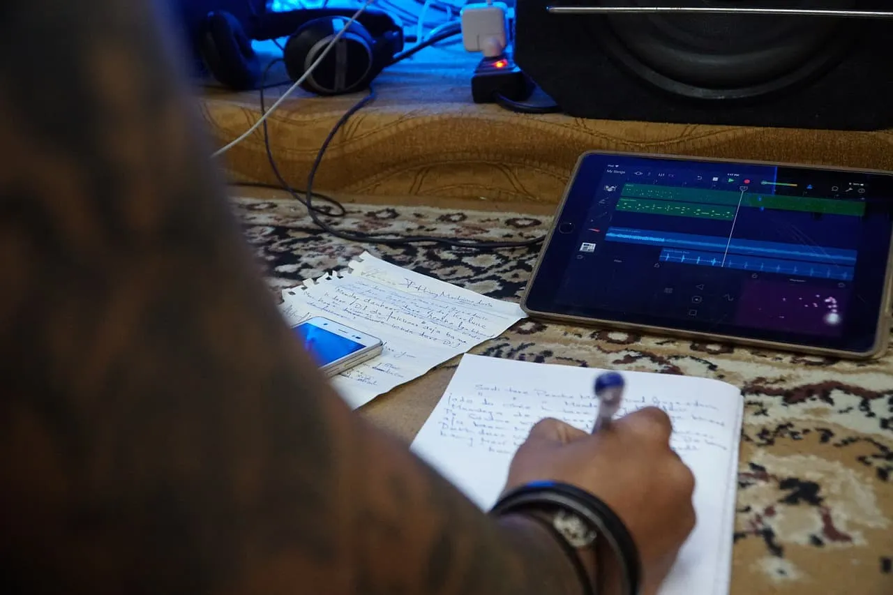 Mobile device with music production software and handwritten notes on a patterned rug, capturing music creation or podcast ed