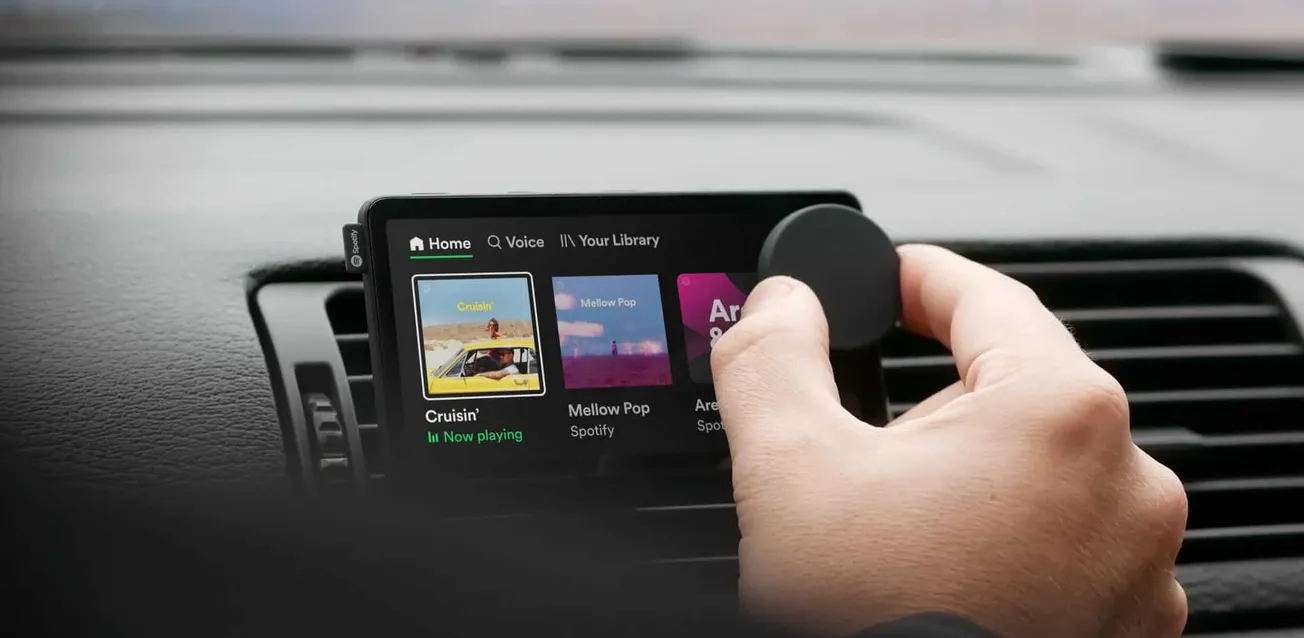 Streamlined car dashboard with Spotify music app displaying playlist options for drivers and music enthusiasts.