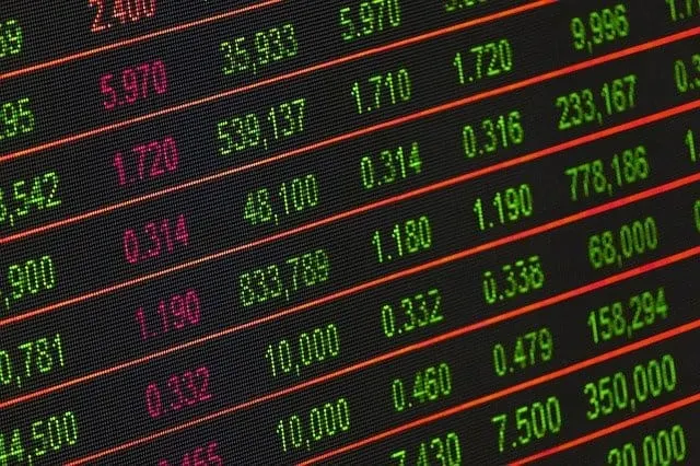 Stocks market trading screen with green and red data numbers displaying financial performance, stock prices, and market data,