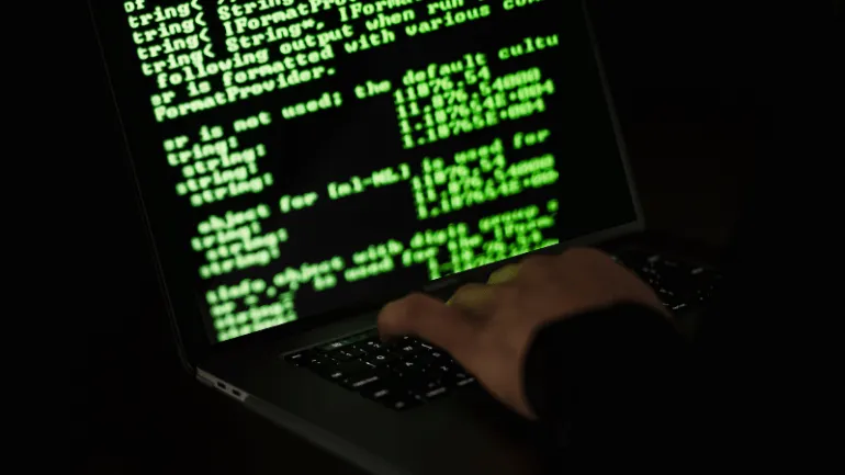 Hypebot cybersecurity hacking code on laptop screen strategic for music industry digital security.