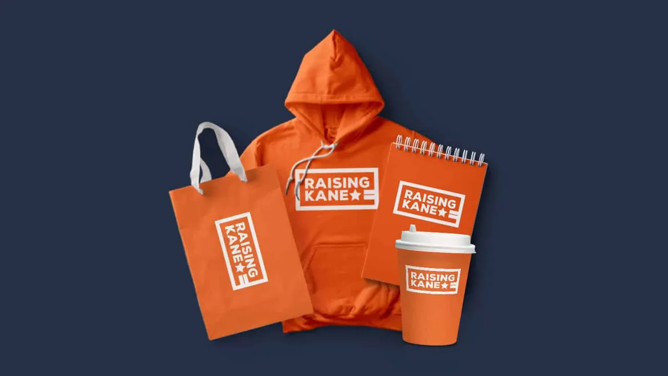 Raising kane merchandise collection with branded hoodie, tote bag, notebook, and coffee cup featuring the raised kane logo an