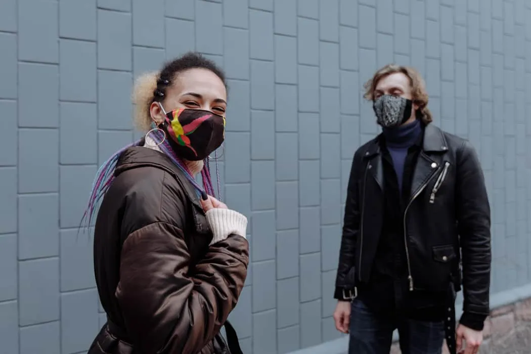 Young diverse people wearing face masks outdoors on city street, safety during pandemic, social distancing, urban lifestyle,