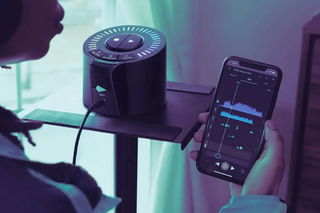 Portable Bluetooth speaker connected to a smartphone with music editing app, highlighting music streaming, audio technology,