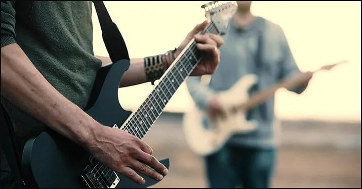 Guitarists performing outdoors during sunset, live music session, vibrant guitar playing, music festival, outdoor concert, mu
