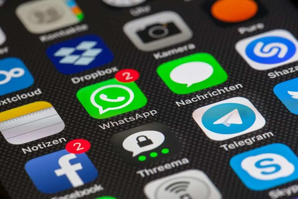WhatsApp notification icons on a smartphone screen with messaging apps and social media logos.