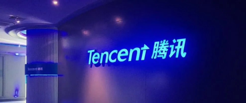 Tencent logo illuminated on a modern corporate wall, representing a major technology and social media company, emphasizing in