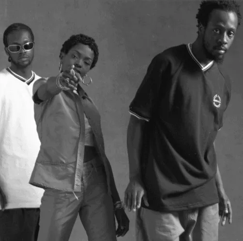 Stylish Black music group posing for a photo in casual streetwear, emphasizing hip-hop culture and urban fashion elements.