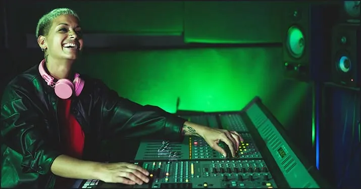 Woman DJ mixing music in a professional studio with vibrant green lighting, electronic music gear, and sound equipment for mu