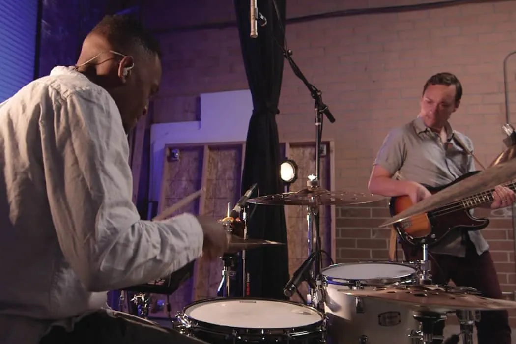 Professional jazz band playing live music in studio, musicians with drums and bass guitar, dynamic performance, music session