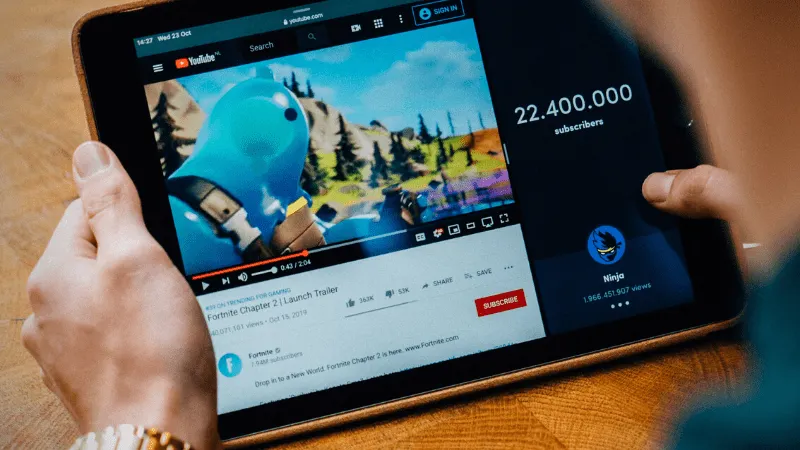 Fortnite gameplay on YouTube with 22 million subscribers, featuring a popular gaming character, digital screen showing video