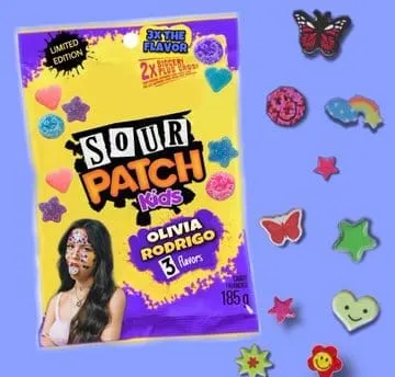 Crunchy sour patch kids candy package with colorful candies surrounding it, highlighting fun and playful branding for kids.