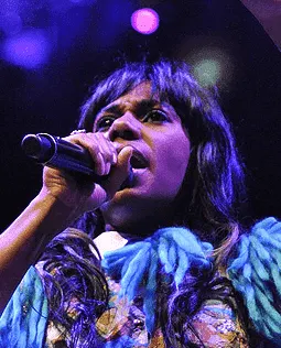 Creative female singer performing on stage with microphone, music, live concert, vocal performance, entertainment, Hypebot.