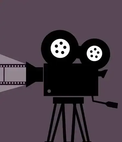 Vintage film camera on tripod with film reels, behind the scenes of film production, cinematic equipment, filmmaking process,