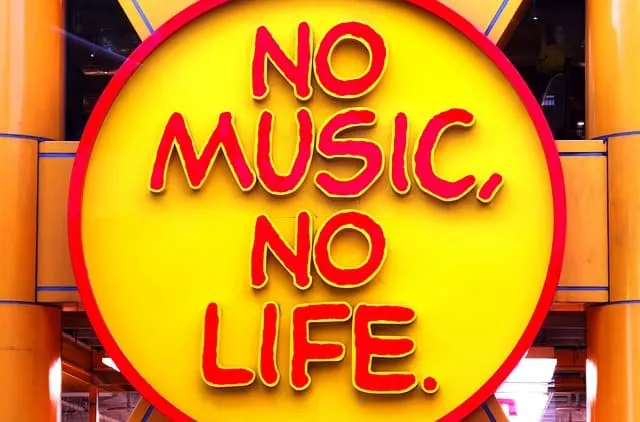 No music, no life sign displayed in a vibrant yellow and red circular background at an amusement park or entertainment venue.