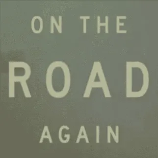 Road sign with "On The Road Again" message, symbolizing travel and music journeys, on a muted green background.