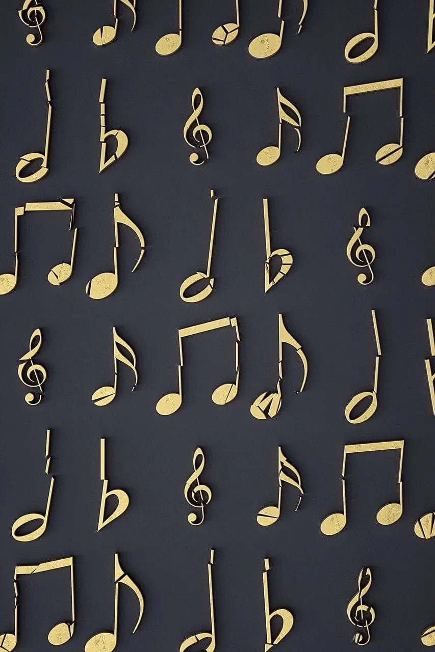 Shiny gold musical notes and symbols on a dark background representing music, rhythm, and sound for music industry branding a