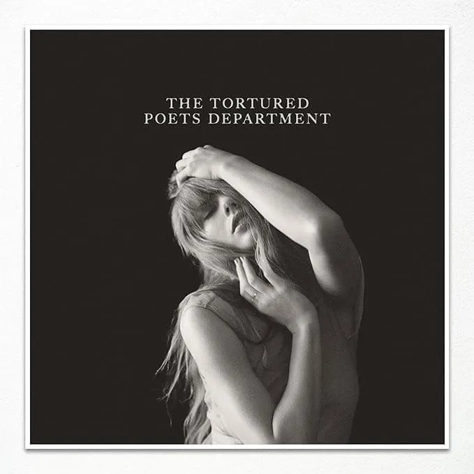 Photograph of a woman with long hair touching her face and head portrayed in black and white, album cover art for The Torture