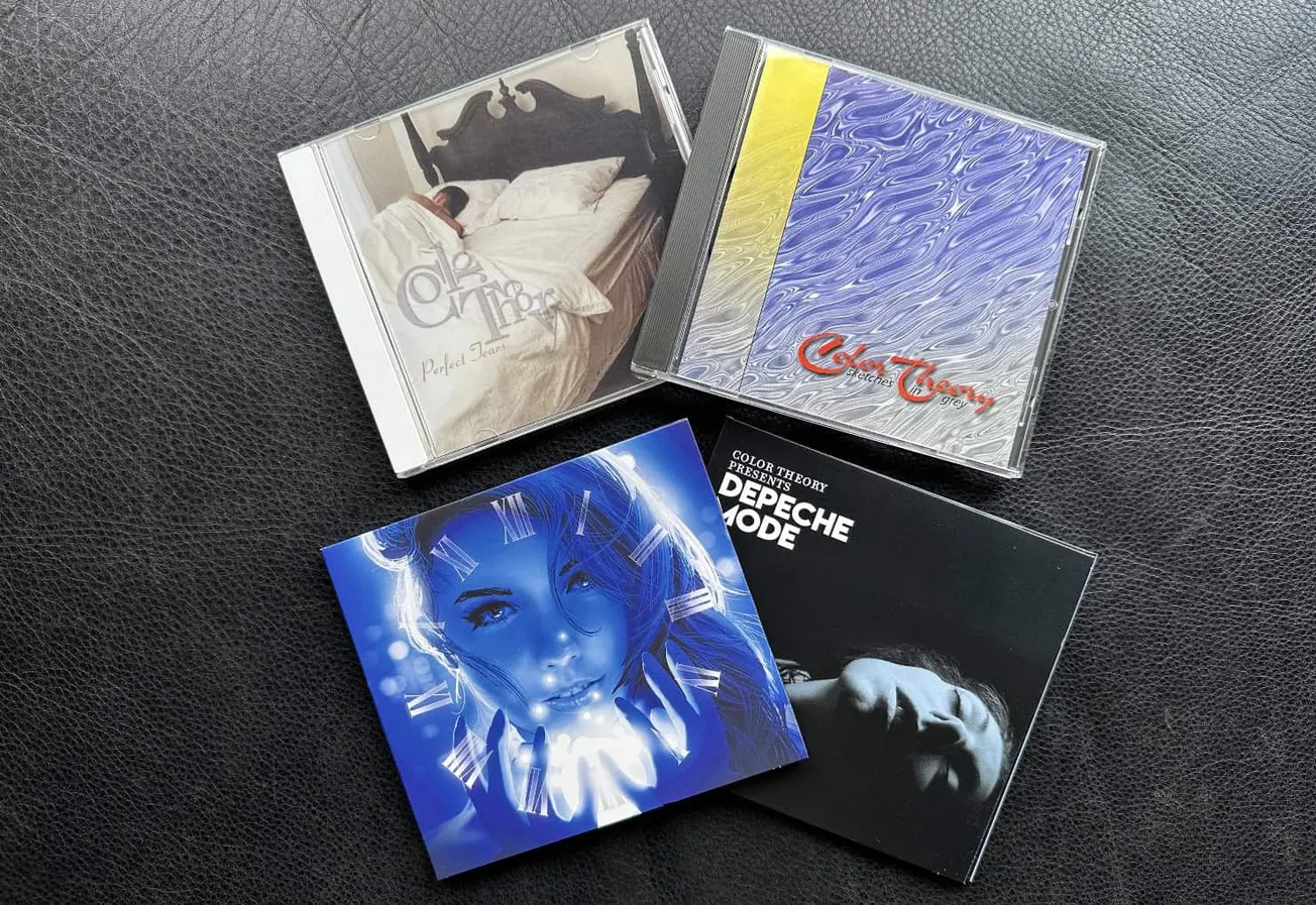CD albums showcasing music from Depeche Mode and other artists, featuring artistic cover designs and vibrant artwork, placed