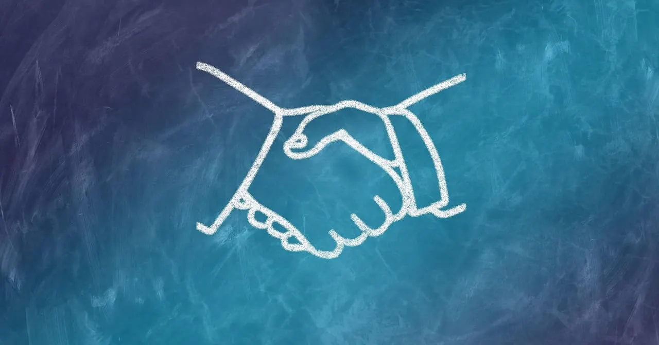 Handshake illustration on chalkboard representing collaboration and partnerships in the music industry or digital media.