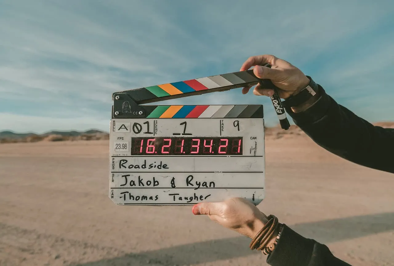 Clapperboard filming desert landscape behind the scenes of a movie production outdoor film set film crew in action.