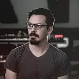 Tech entrepreneur in a modern recording studio with audio equipment and sound mixing devices for music production and digital