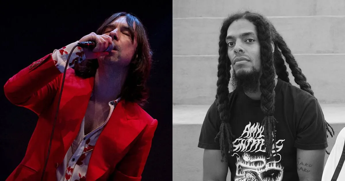 A singer passionately performing on stage with a microphone, dressed in a red blazer, immersed in music performance.