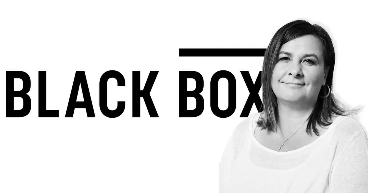 Empowered woman standing in front of Black Box music industry logo, symbolizing innovation and leadership in the music and en