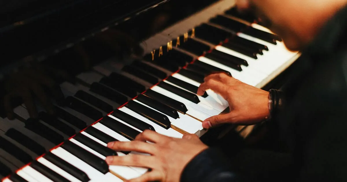closeup of pianist's hands on piano