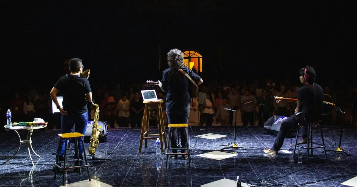 band on stage giving a presentation.