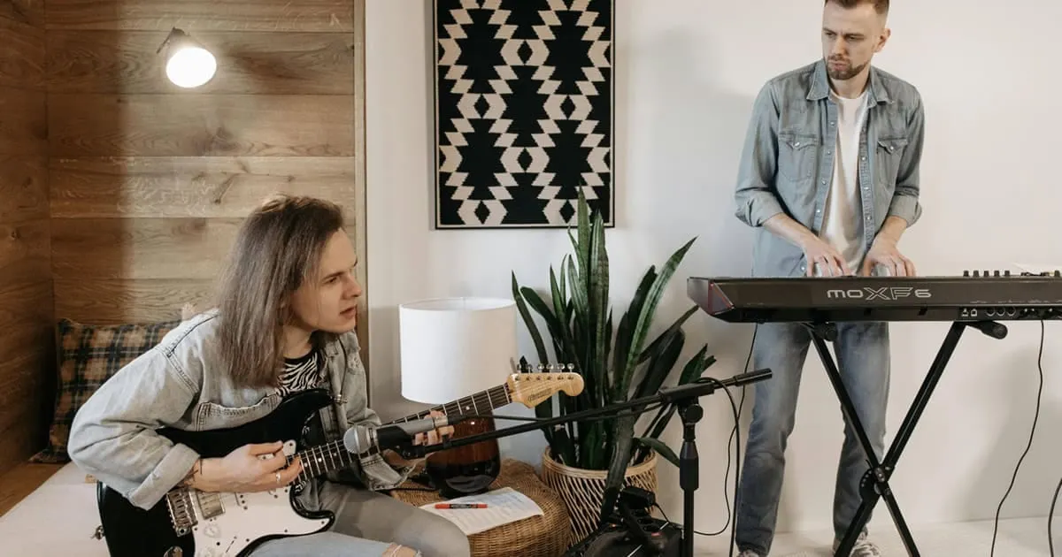 Teens practicing music at home, young musicians with electric guitar and keyboard, cozy indoor setting, creative music sessio