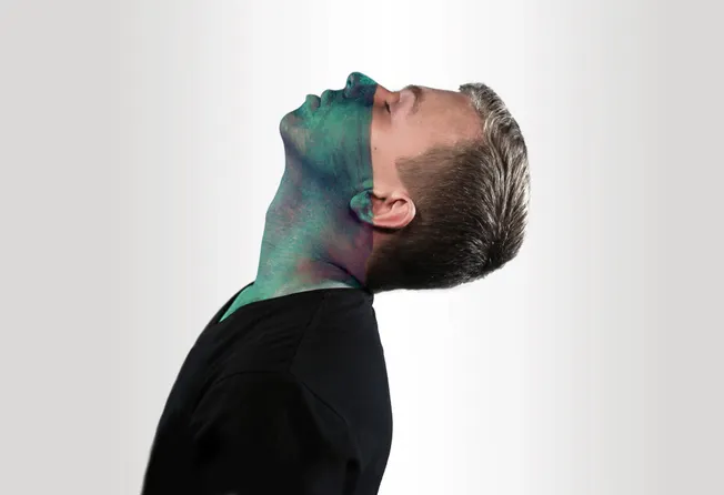 Vibrant face paint art on a man's face, blending artistic design with contemporary style, emphasizing creativity and self-exp