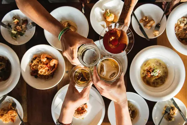 Cheers-ing-with-beer-and-wine-at-dinner-party-celebration-reward.