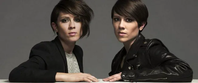 Bold women with short hairstyles wearing leather and blazer jackets, posing confidently against a dark gray background, repre