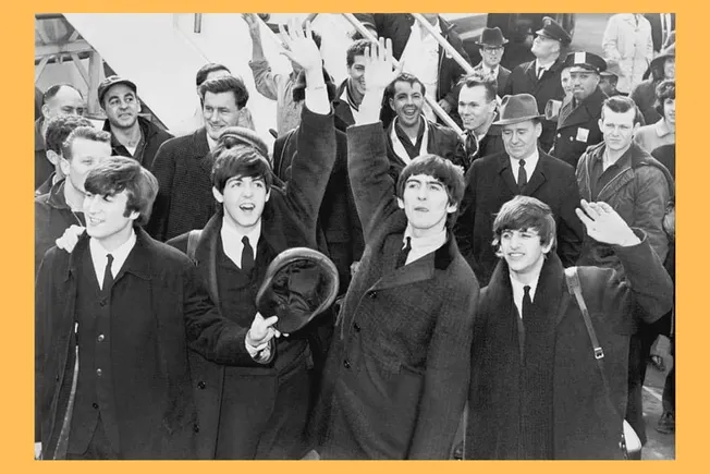 People raising their hands at a public event, vintage black and white photo of young men smiling, crowd gathering, historical