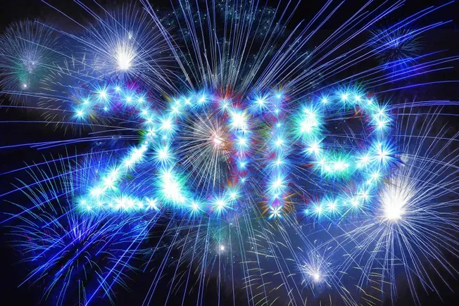 Fireworks display forming "2024" for New Year celebration, colorful bright sparks and starbursts in night sky, festive event,