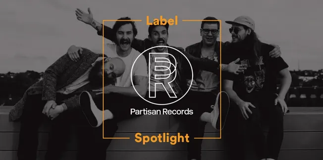 Friends group photo on a rooftop with Partisan Records logo, music branding, and modern entertainment vibe.