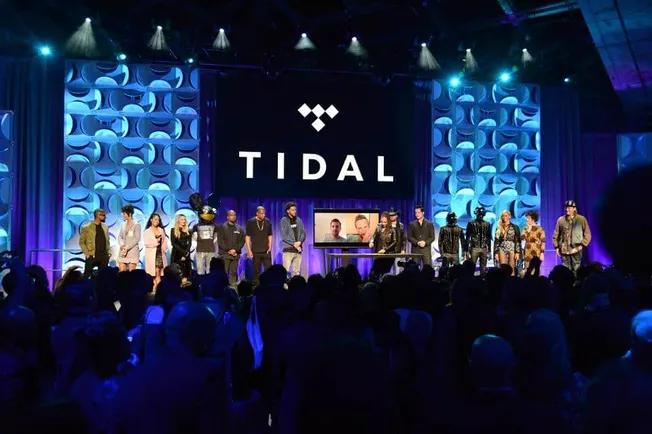 Tidal brand presentation on stage during a music industry event, featuring mannequins and virtual screens, highlighting music
