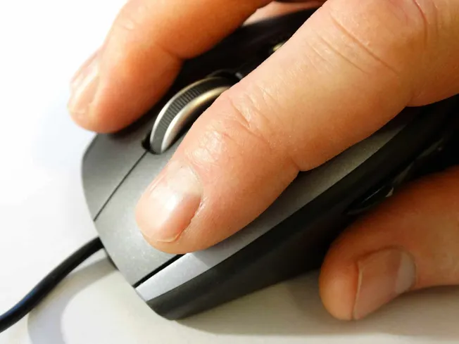 Mouse cursor clicking on a computer mouse, close-up shot, emphasizing digital technology, online marketing, and music streami